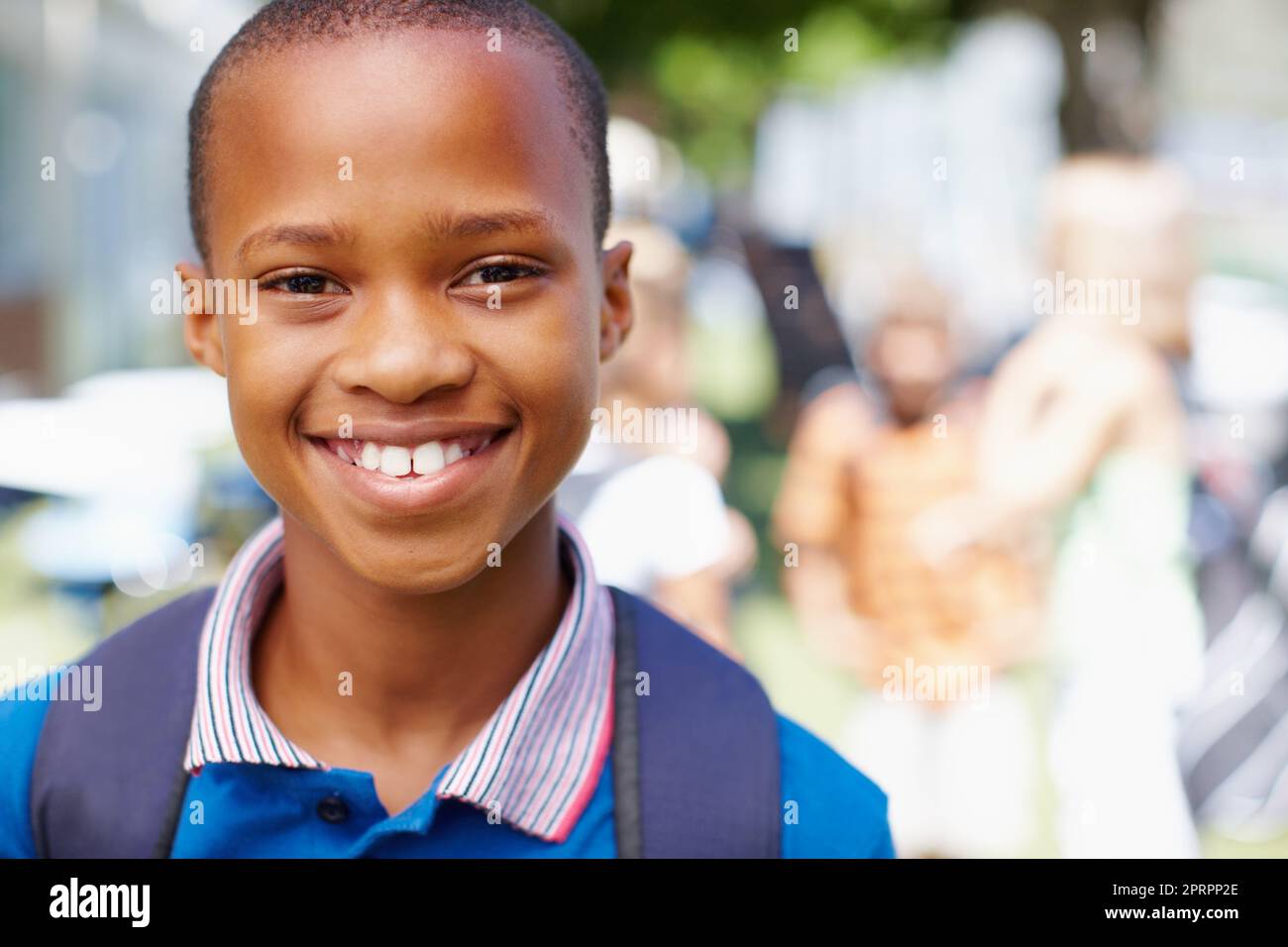 Im ready for a new school year. Confident african-american boy smiling at you with schoolmates in the background - copyspace. Stock Photo