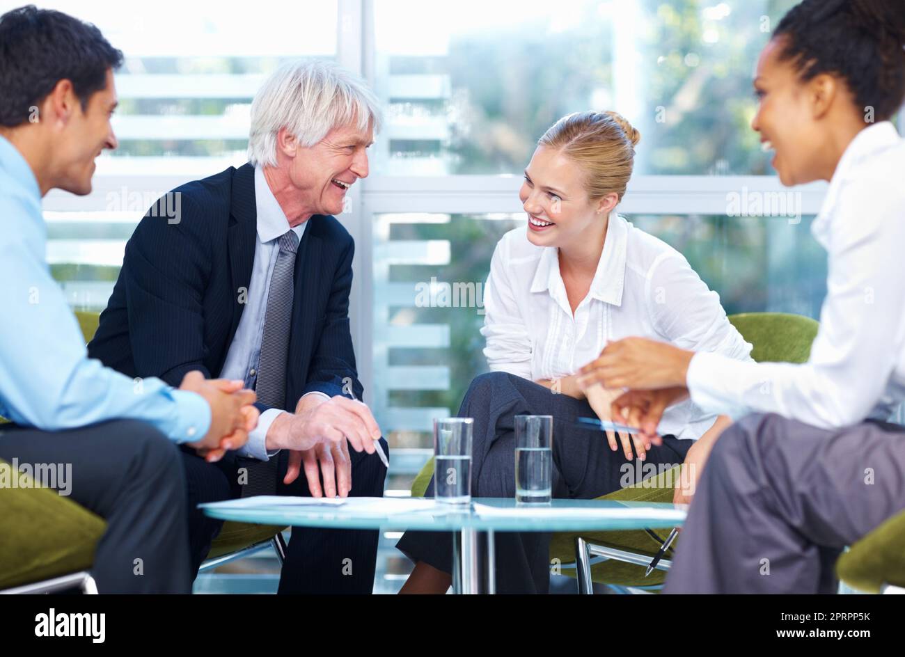 Business team in happy discussion. Portrait of multi ethnic business team having happy discussion at office. Stock Photo