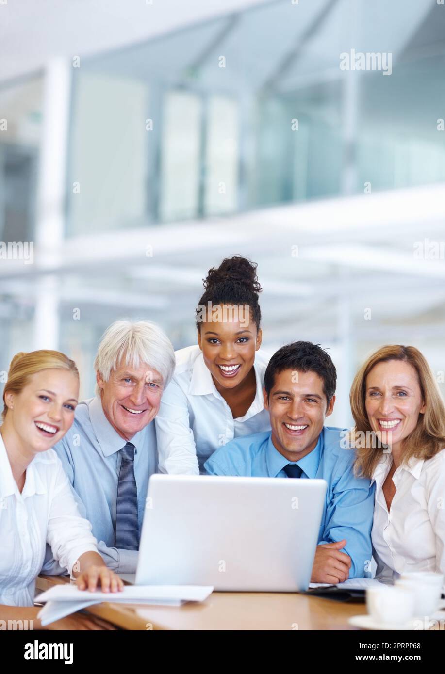 Working together. Portrait of successful multi ethnic business people working together on laptop. Stock Photo