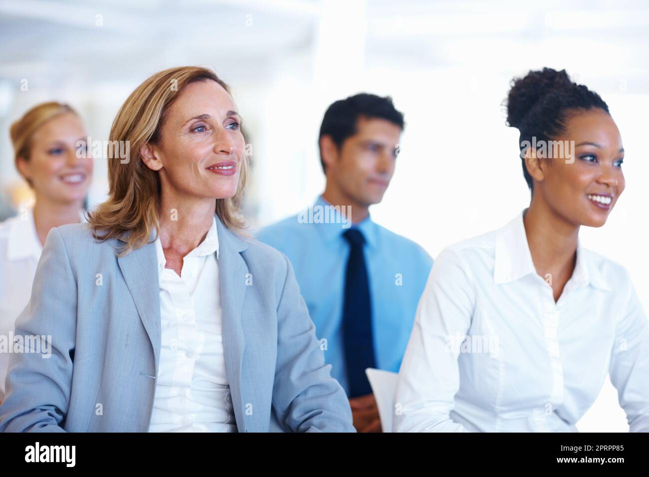 Business people sitting at seminar. Portrait of multi racial business people sitting at seminar. Stock Photo