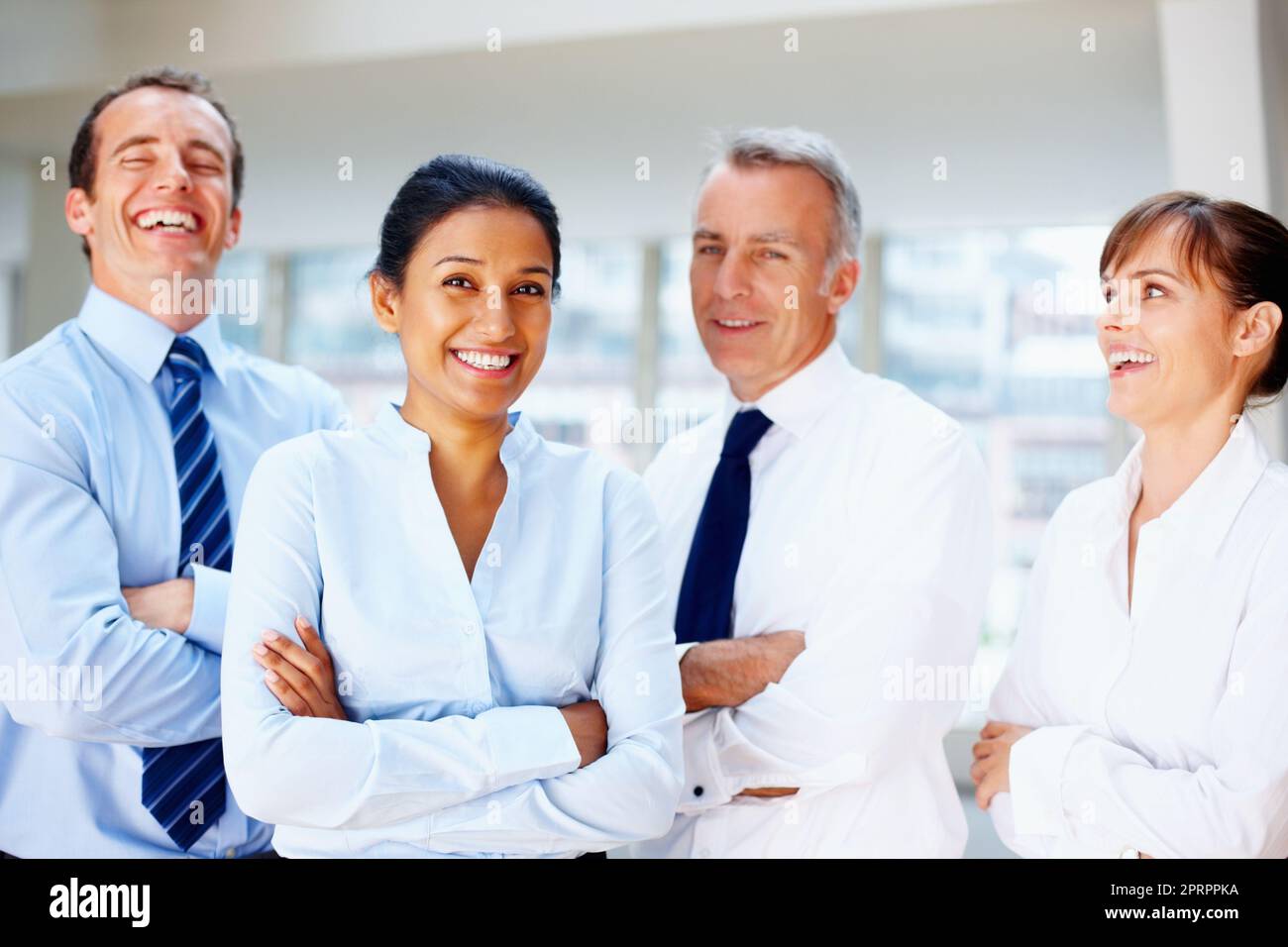 Friendly team of professionals. Professionals laughing while at work. Stock Photo