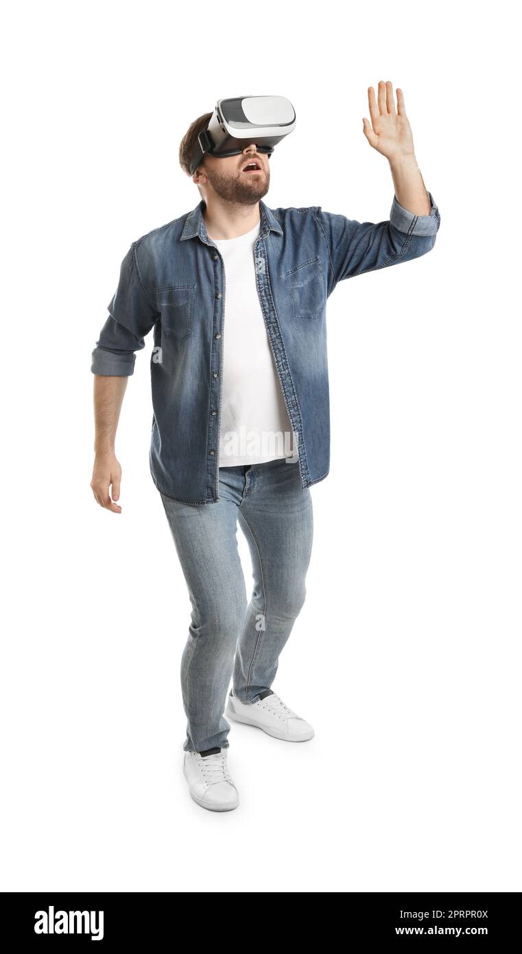 Emotional man using virtual reality headset on white background Stock Photo
