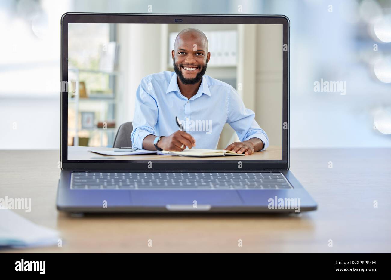 Video conference, digital and laptop with businessman in meeting, planning and online on desk in office building. Video call, consulting and webinar of black man with internet, employee and virtual Stock Photo