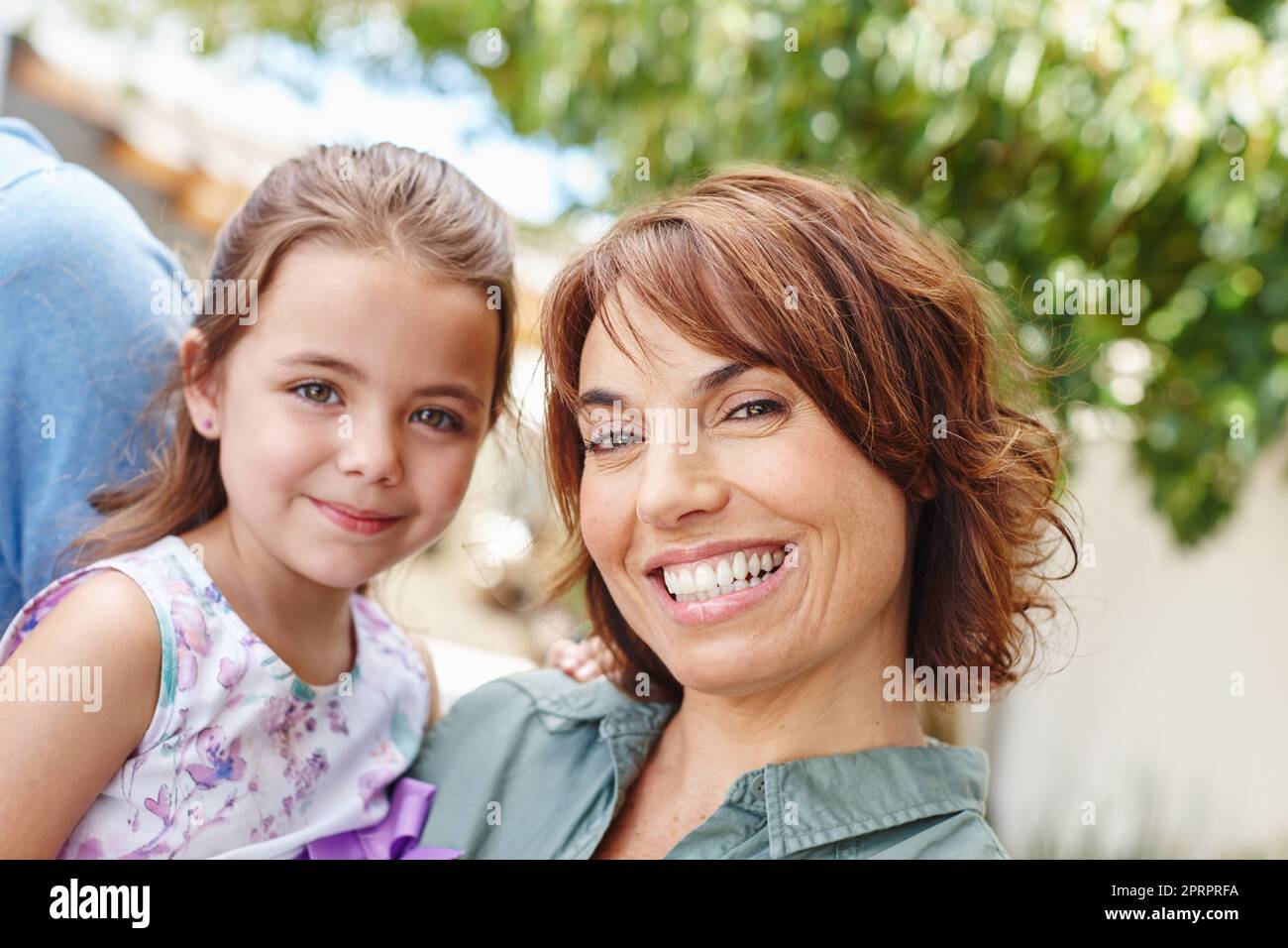 She means the world to me. Portrait of a mother and daughter standing