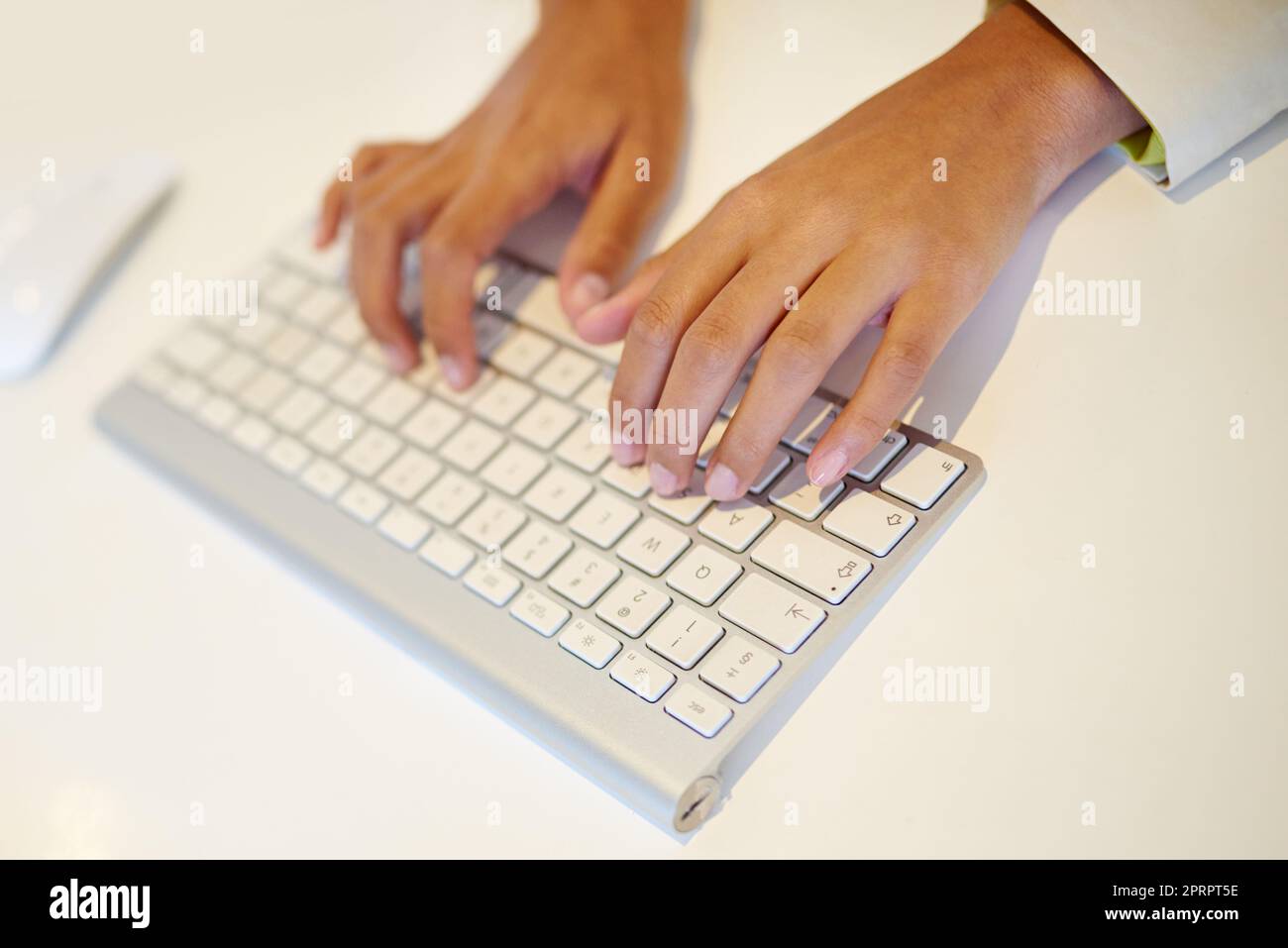 Typing away. a womans hands on a computer keyboard. Stock Photo