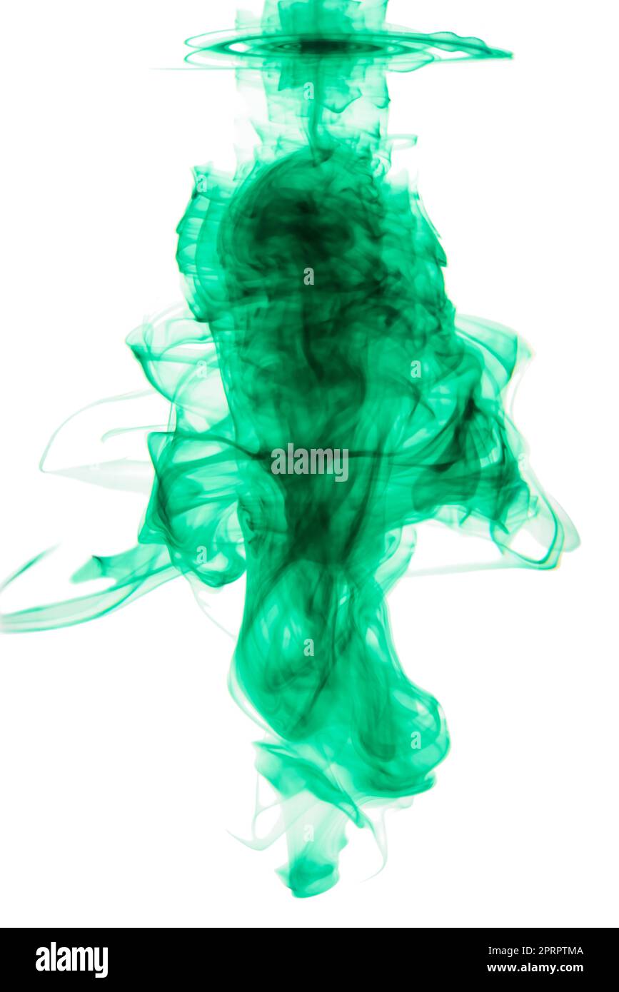 Ink-credibe. Studio shot of green ink in water against a white background. Stock Photo