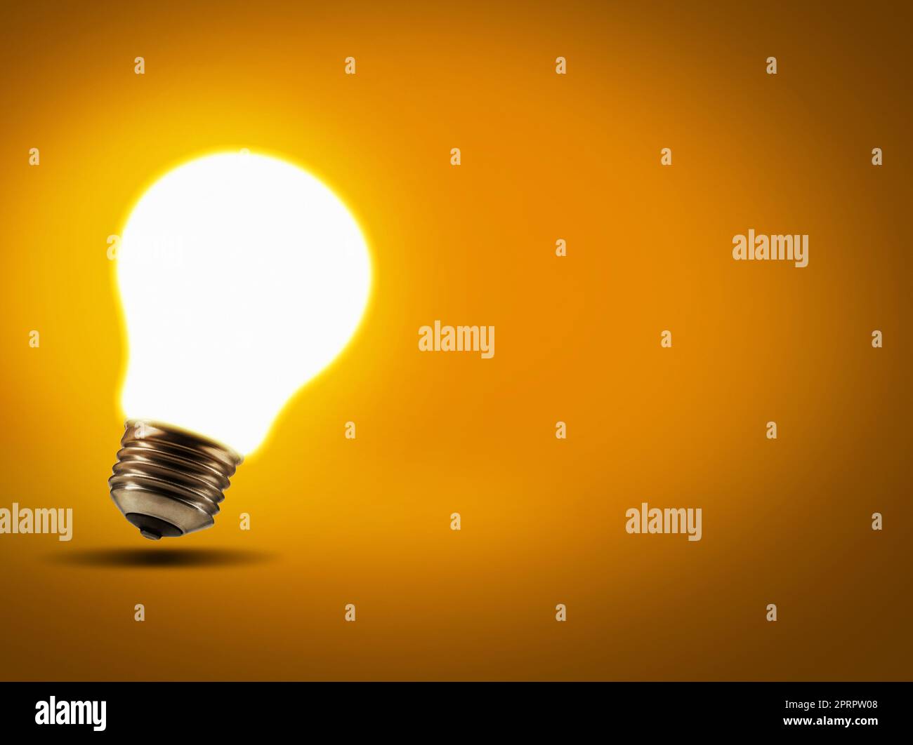 The classic lightbulb moment. Studio shot of a lightbulb against an orange background. Stock Photo