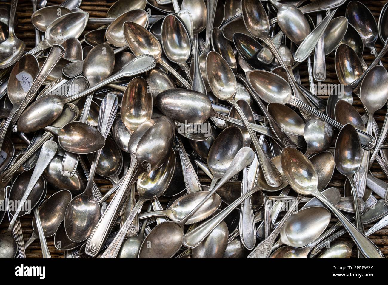Heap of aged silver spoons Stock Photo