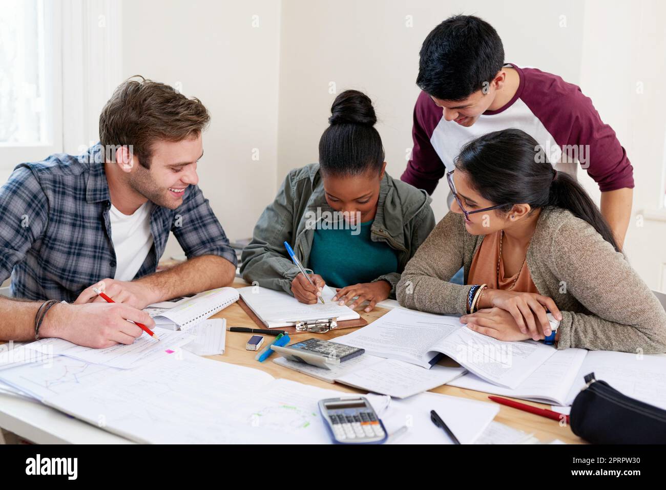 Watching her work. a group of university students in a study group. Stock Photo