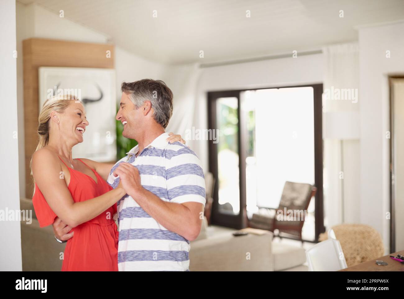 Keeping the romance alive. a happily married couple dancing together at home. Stock Photo