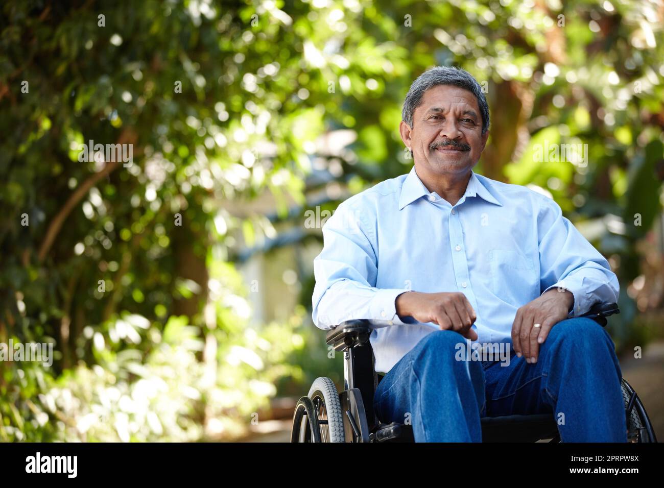 Elderly Man In Wheelchair Sitting Outside Nursing Home Stock Photo