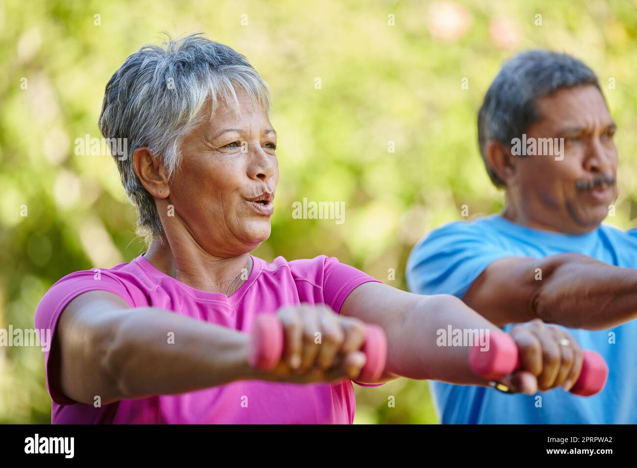 Work those muscles. Portrait of a mature couple exercising together in their backyard. Stock Photo
