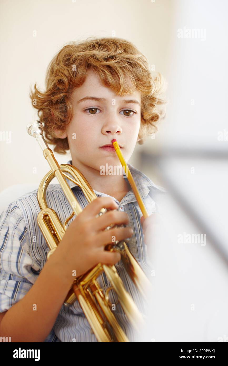 From toys to trumpets. a cute little boy playing the trumpet Stock