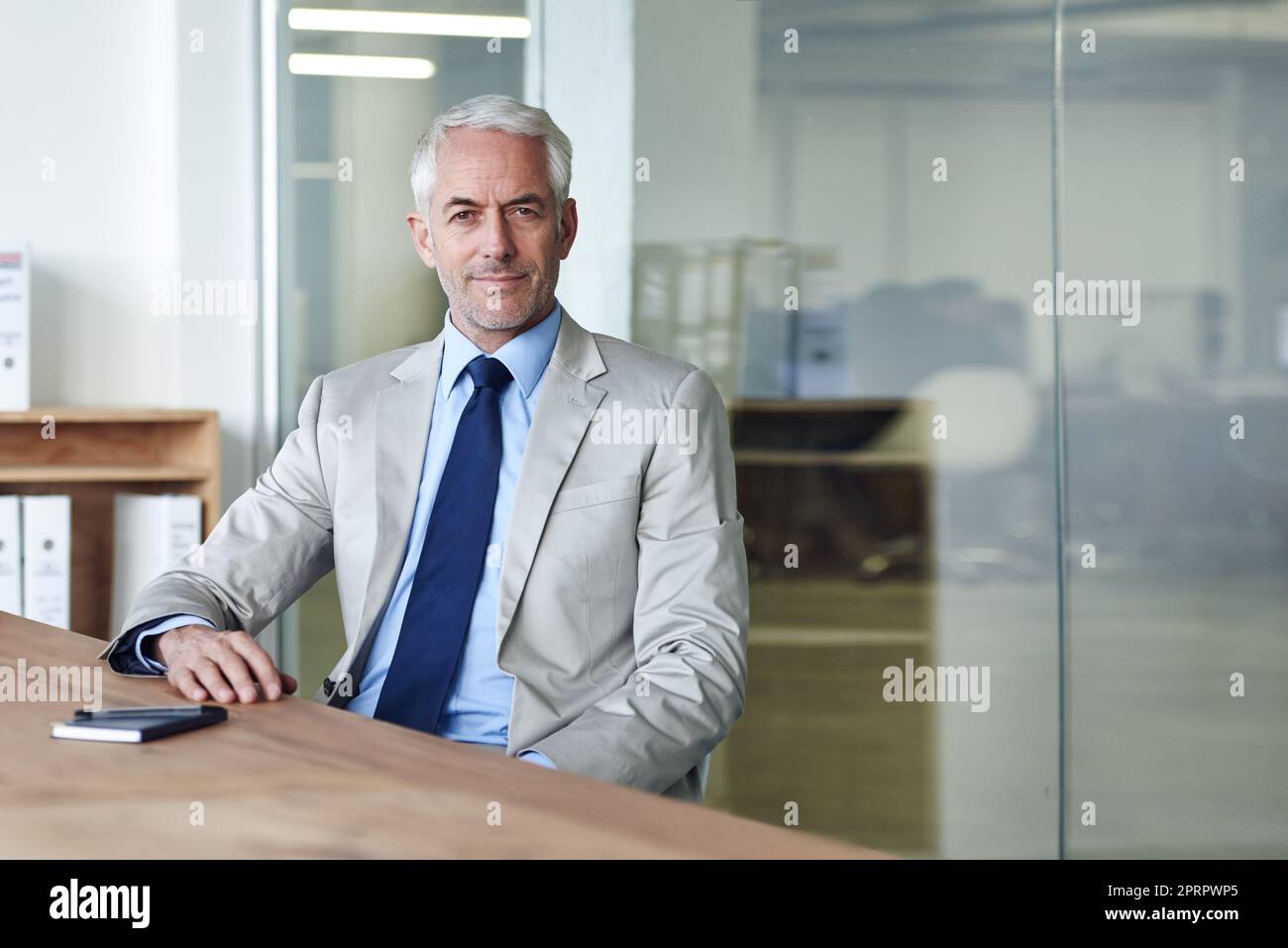 Building this company was a labor of love. Portrait of a mature businessman working on a laptop in an office. Stock Photo