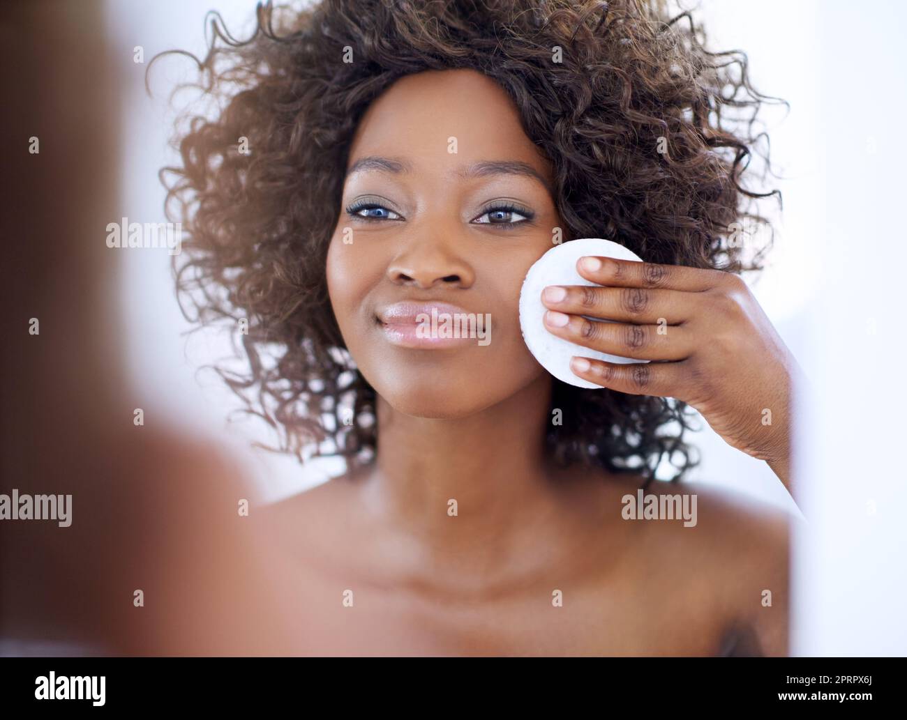 Hello flawless. a beautiful young woman during her daily beauty routine ...