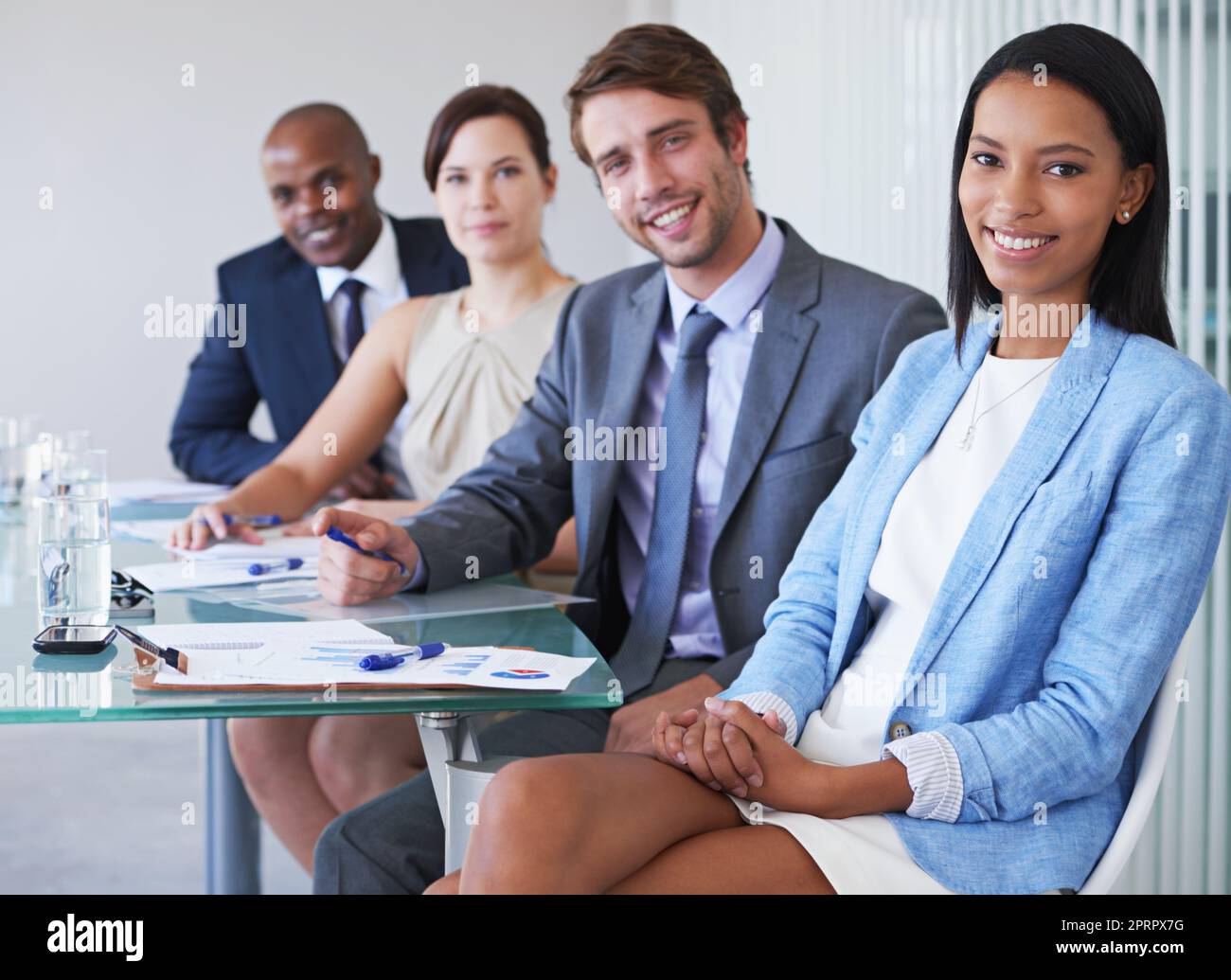 The financial experts. Portrait of a group of businesspeople sitting at a conference table. Stock Photo