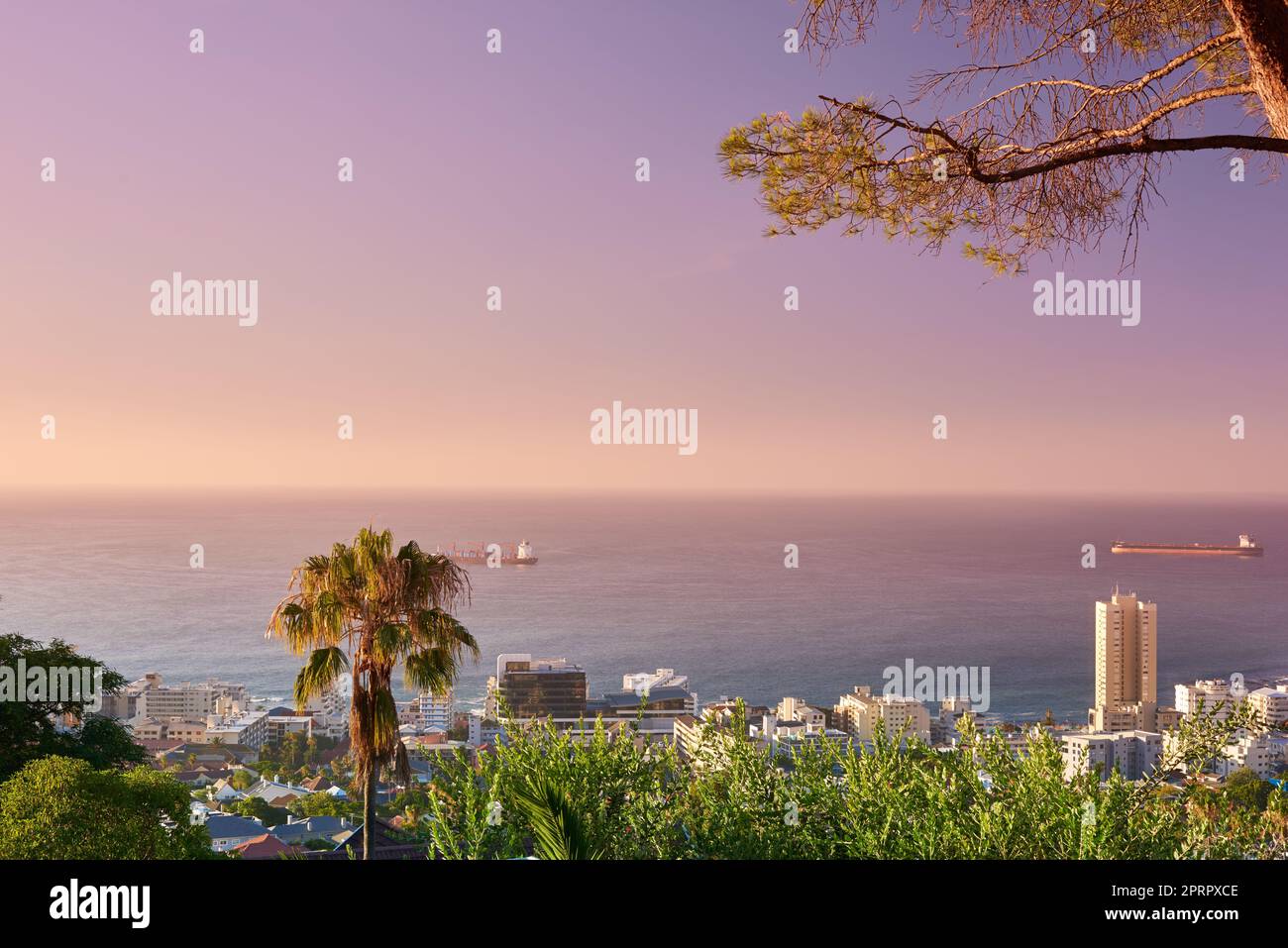 Take a vacation in paradise. a city on the coastline with mountains surrounding it. Stock Photo