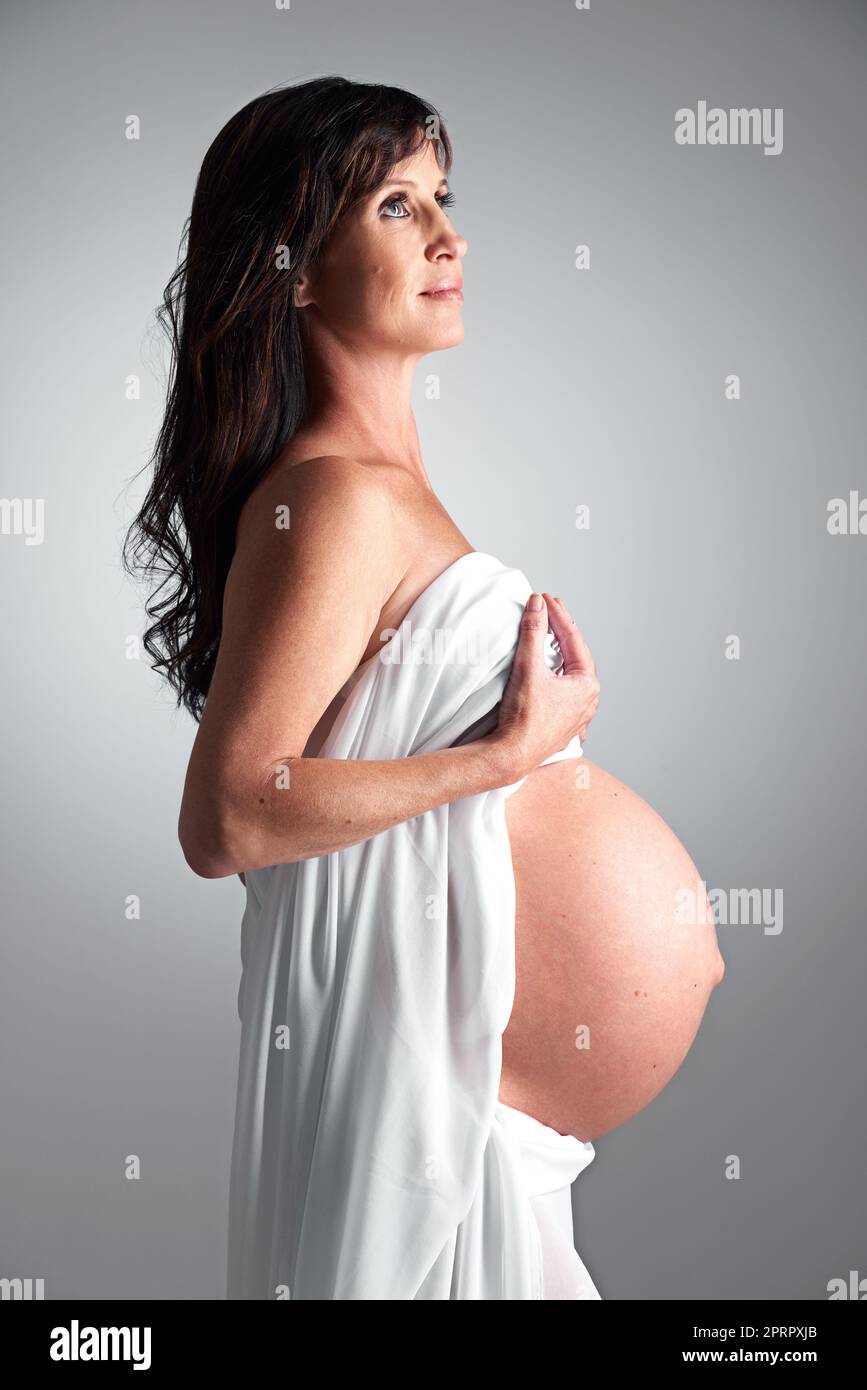 Expecting her arrival soon. A pregnant woman holding her tummy. Stock Photo