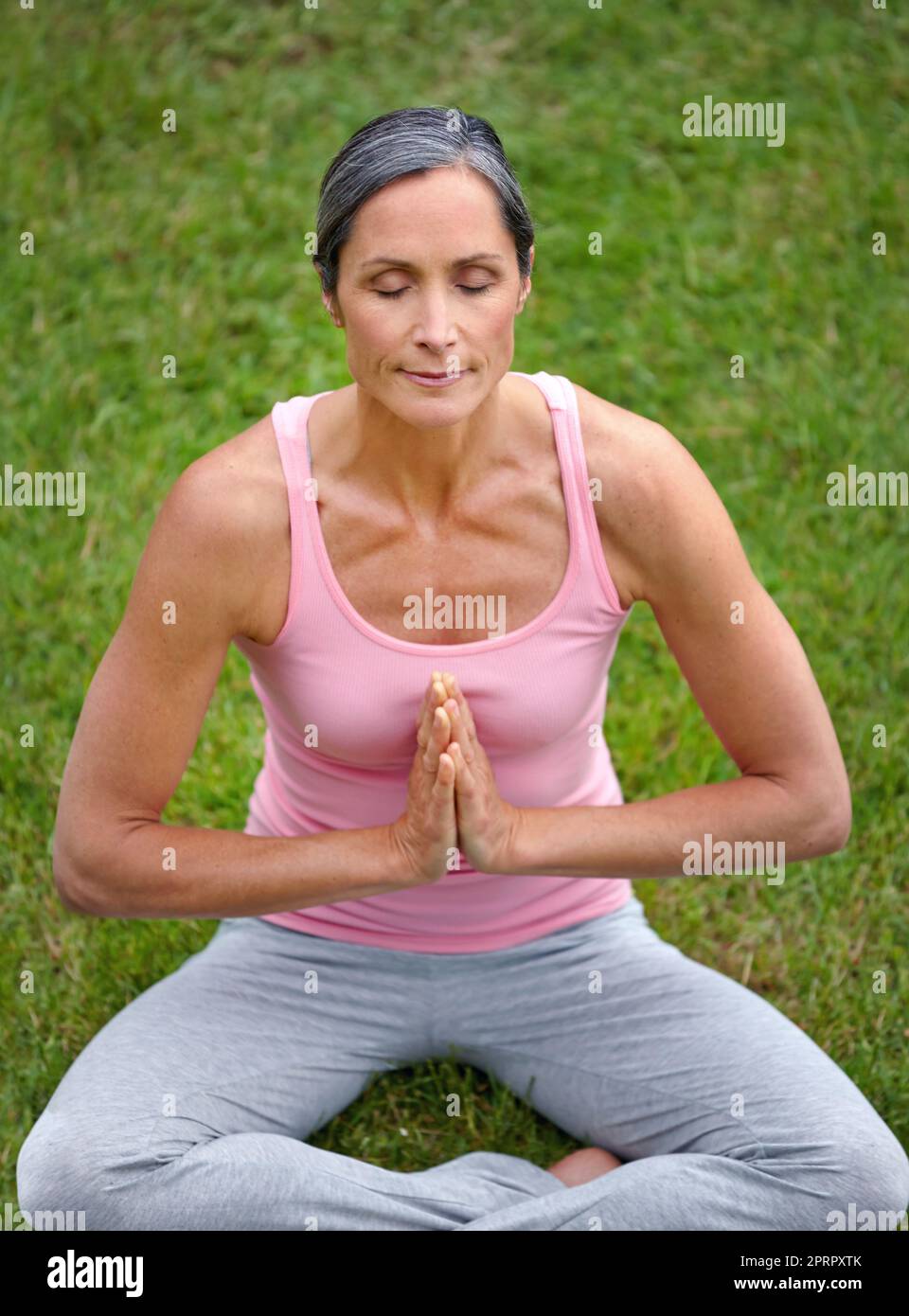 The art of meditation. an attractive mature woman practicing yoga in the lotus position. Stock Photo