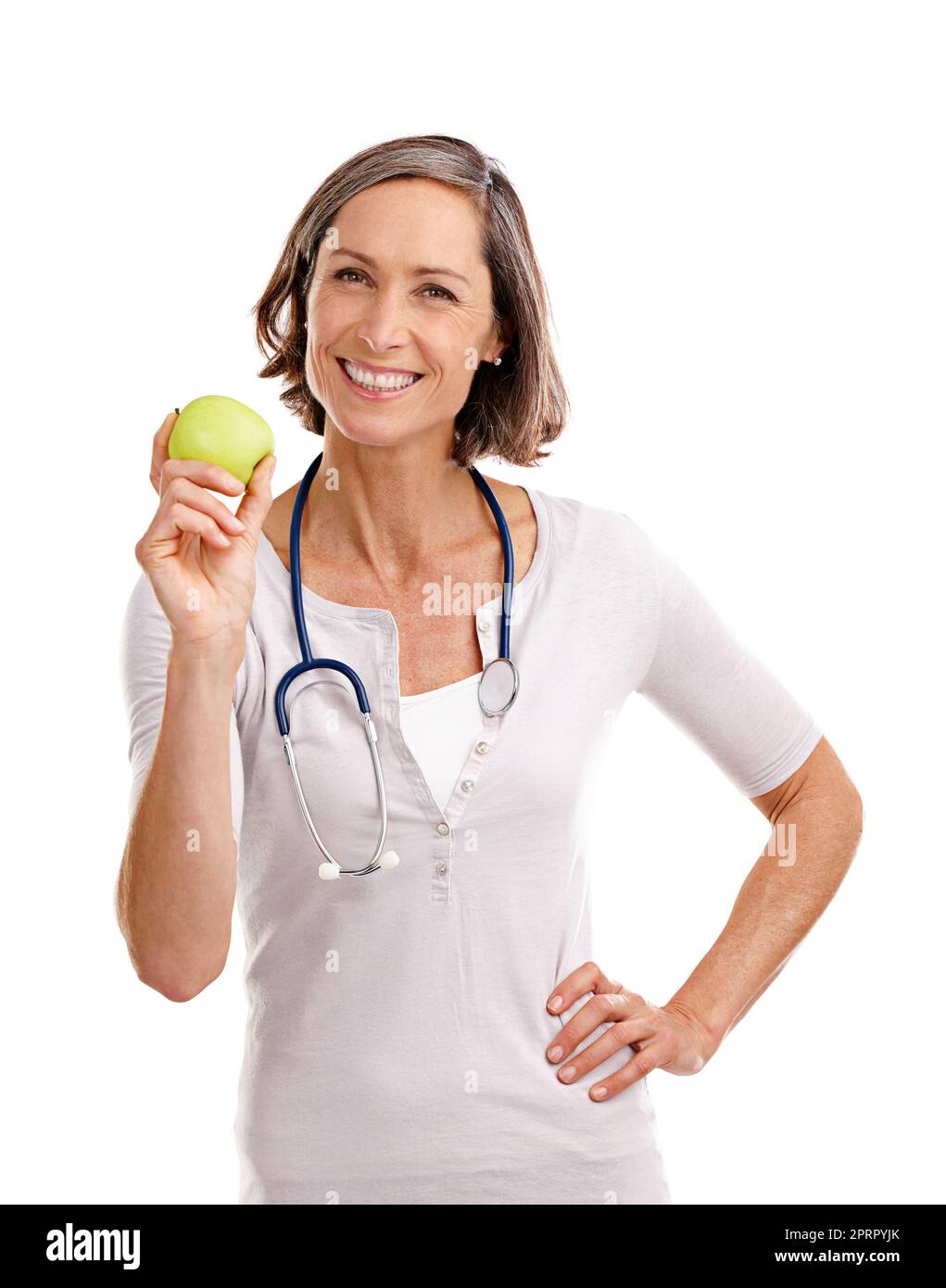 Promoting a healthy lifestyle. Cropped studio portrait of a mature female doctor holding an apple. Stock Photo