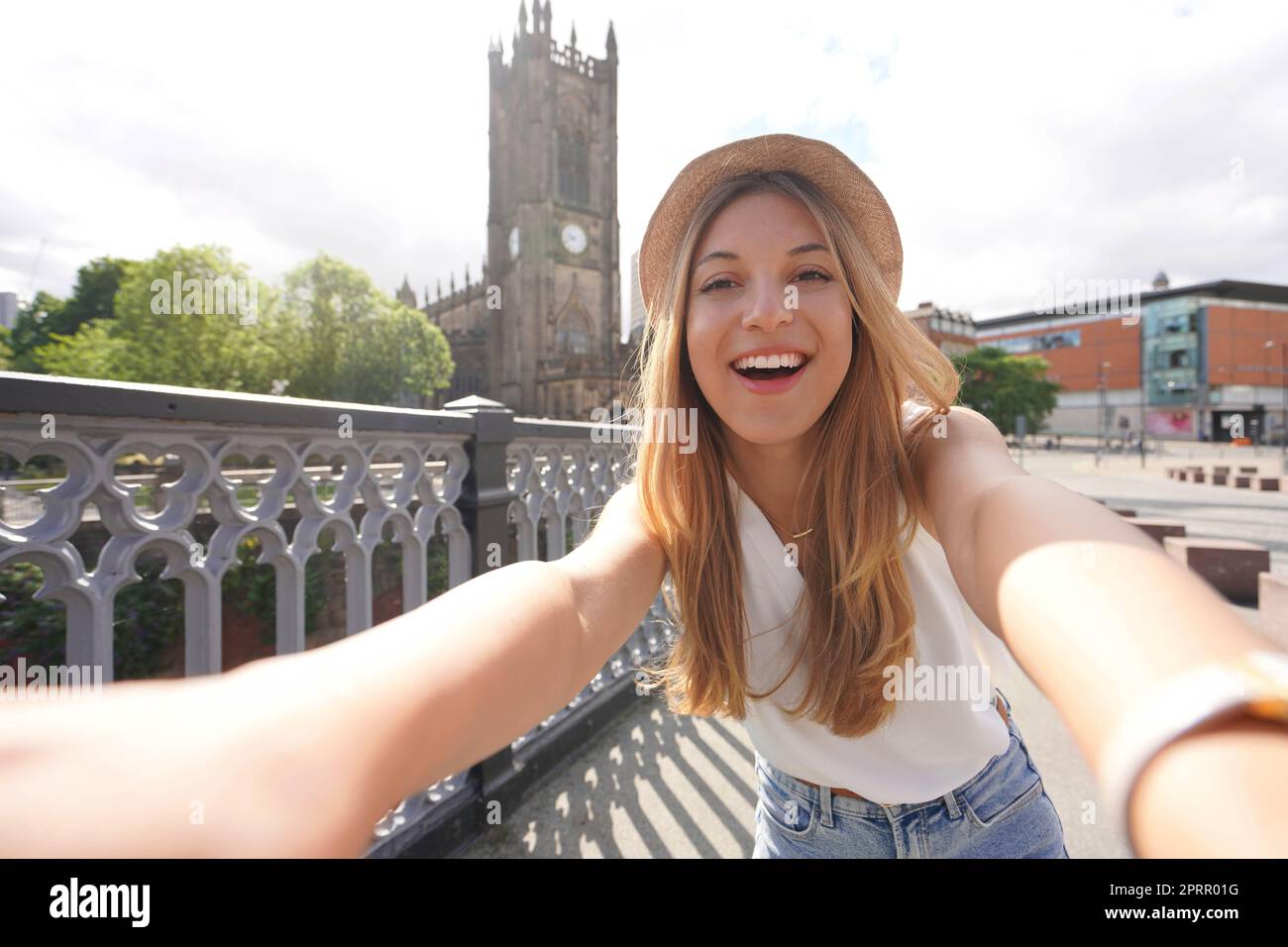 Smiling young woman takes self portrait in Manchester, England, United Kingdom Stock Photo