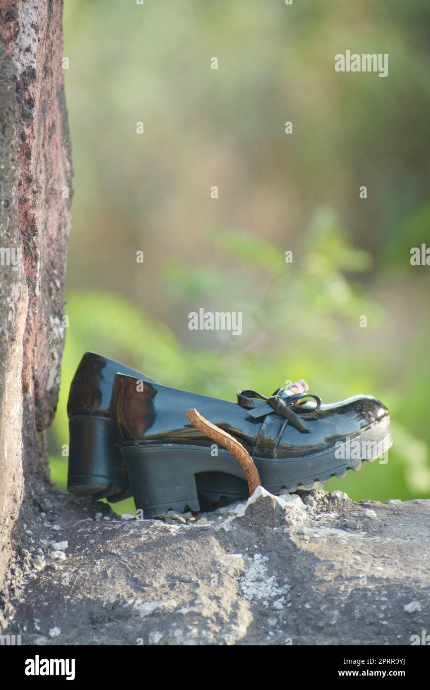 Young girl shoe over vintage stone walllost child concept Stock Photo