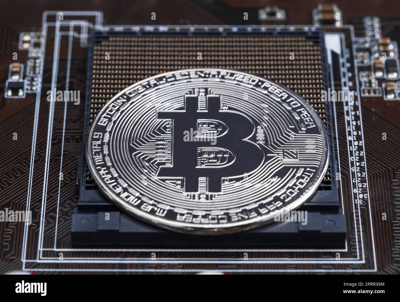 Cryptocurrency bitcoin silver coins on circuit board Stock Photo