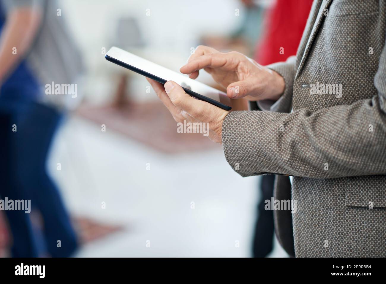 Every businessmans best friend. an office worker using a digital tablet. Stock Photo