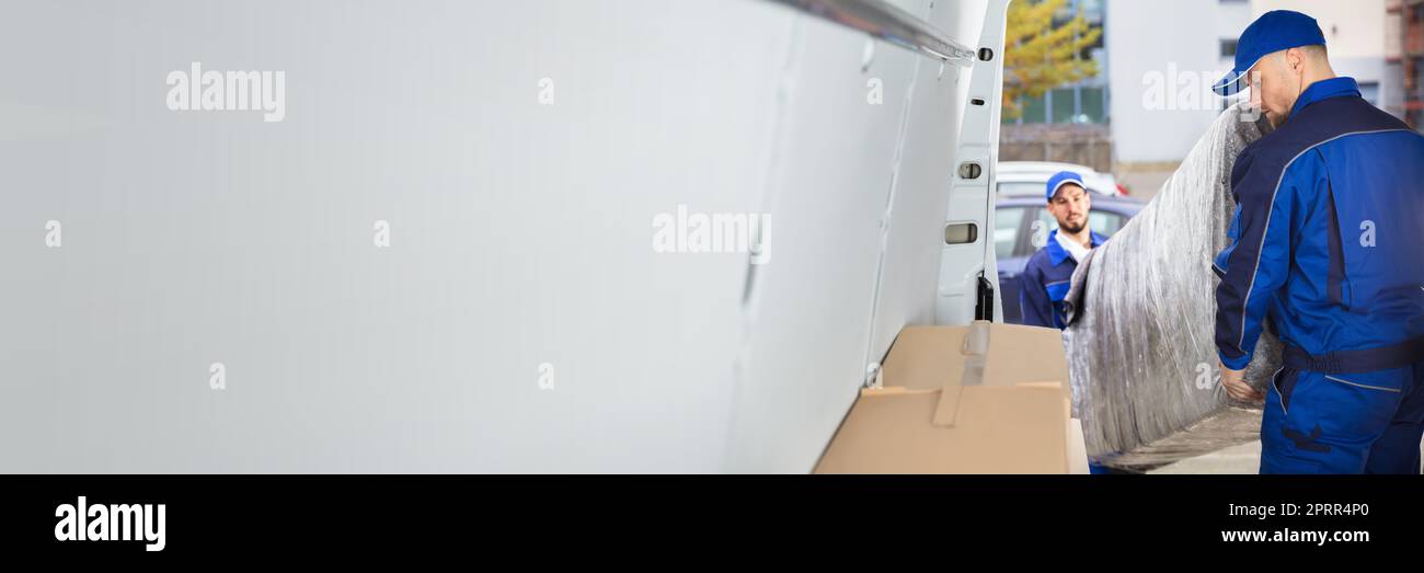 Happy Movers Unloading Furniture From Truck. Mover Service Stock Photo