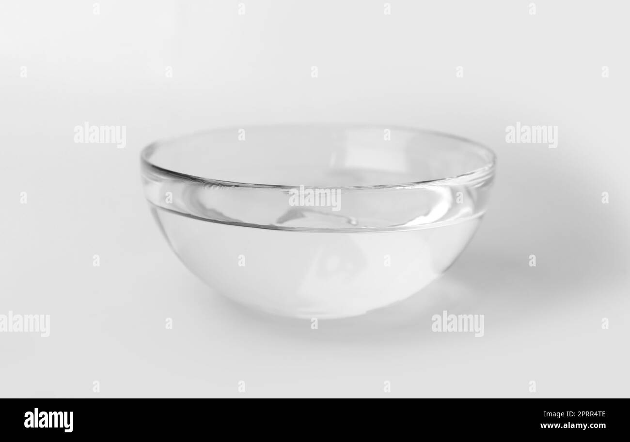 Glass bowl full of water on white background Stock Photo Alamy