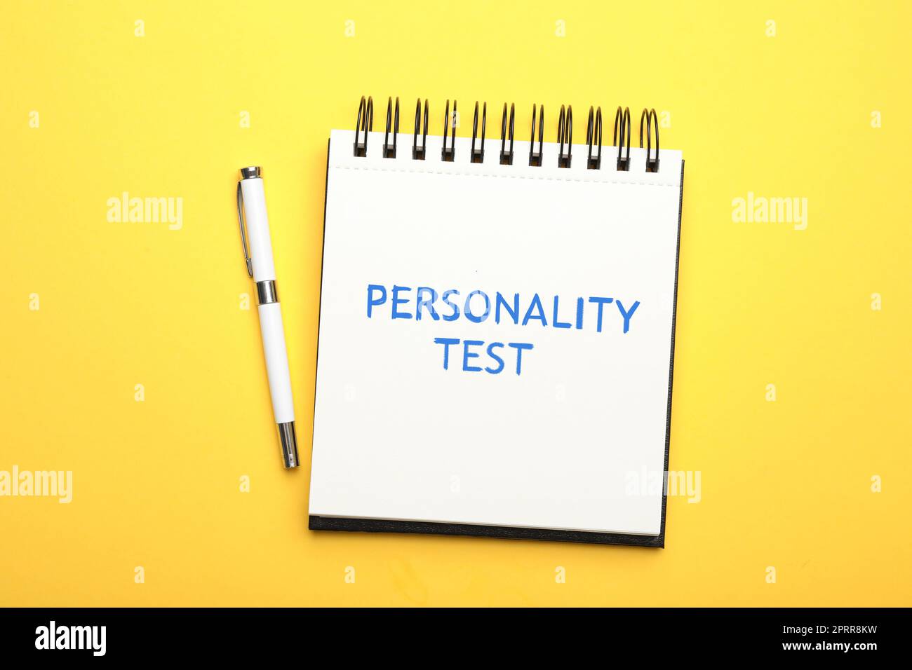 Notebook with text Personality Test and pen on yellow background, top view Stock Photo