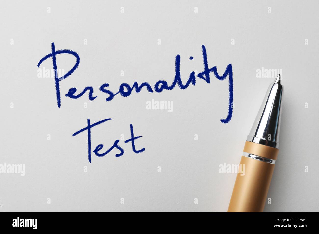 Text Personality Test and pen on white paper, top view Stock Photo