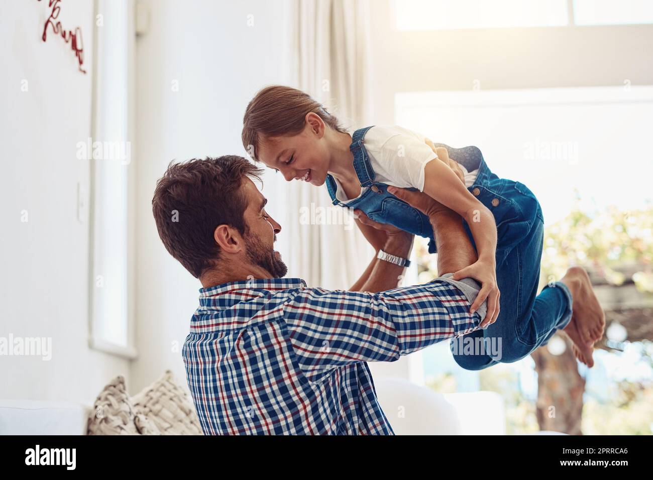 You light up my world like nobody else. an adorable little girl spending time with her father at home Stock Photo