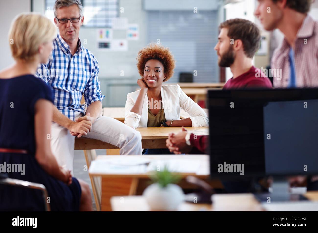 Its an easygoing work environment. a group of designers in their modern office. Stock Photo