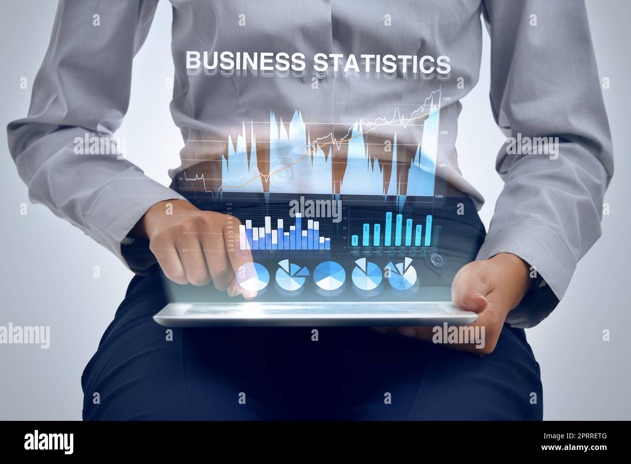 Analyzing business data with the help of technology. a businesswoman using a digital tablet to analyze financial data. Stock Photo