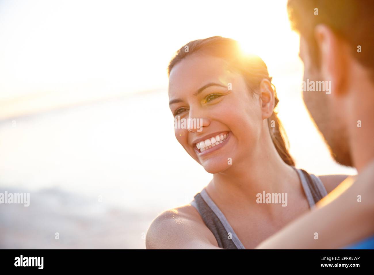 Living a life of joy and romance. a happy young woman with her boyfriend at sunrise. Stock Photo