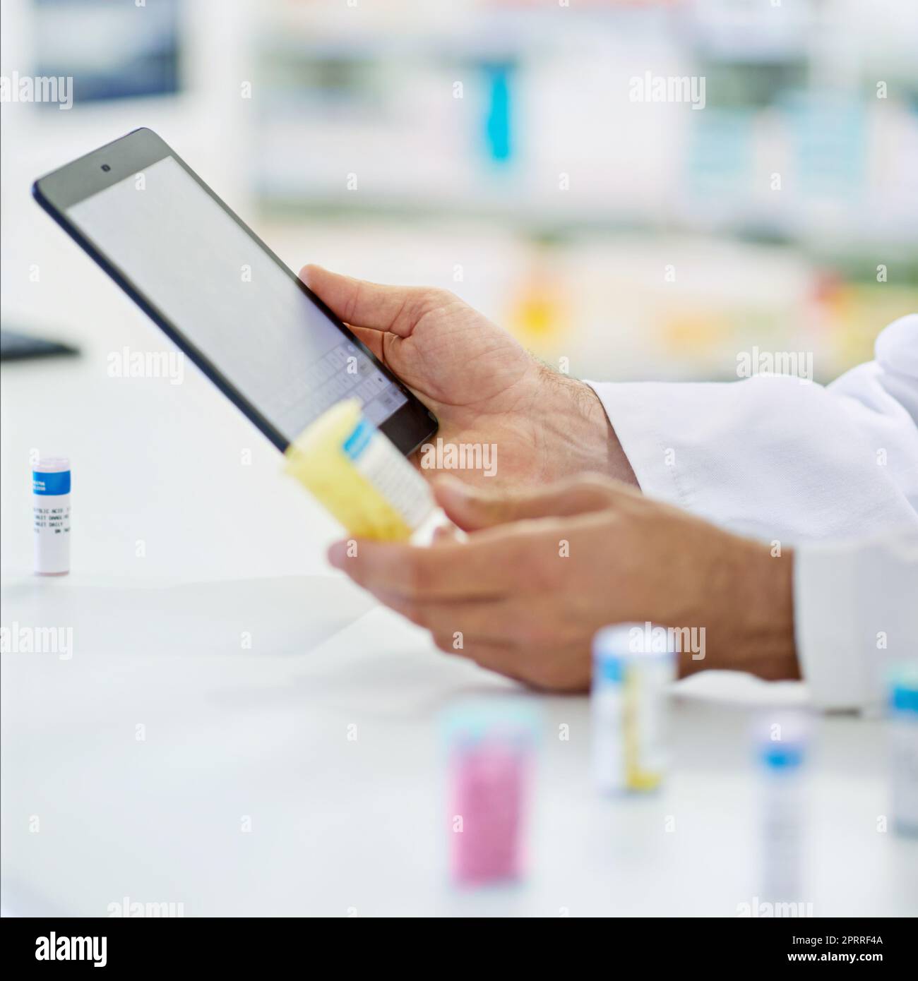 Doing research the modern way. A pharmacist working on a digital tablet. Stock Photo