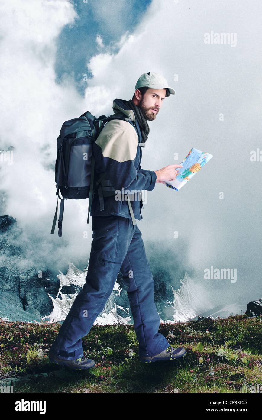Following instructions. a male hiker in extreme terrain using his map as he walks. Stock Photo
