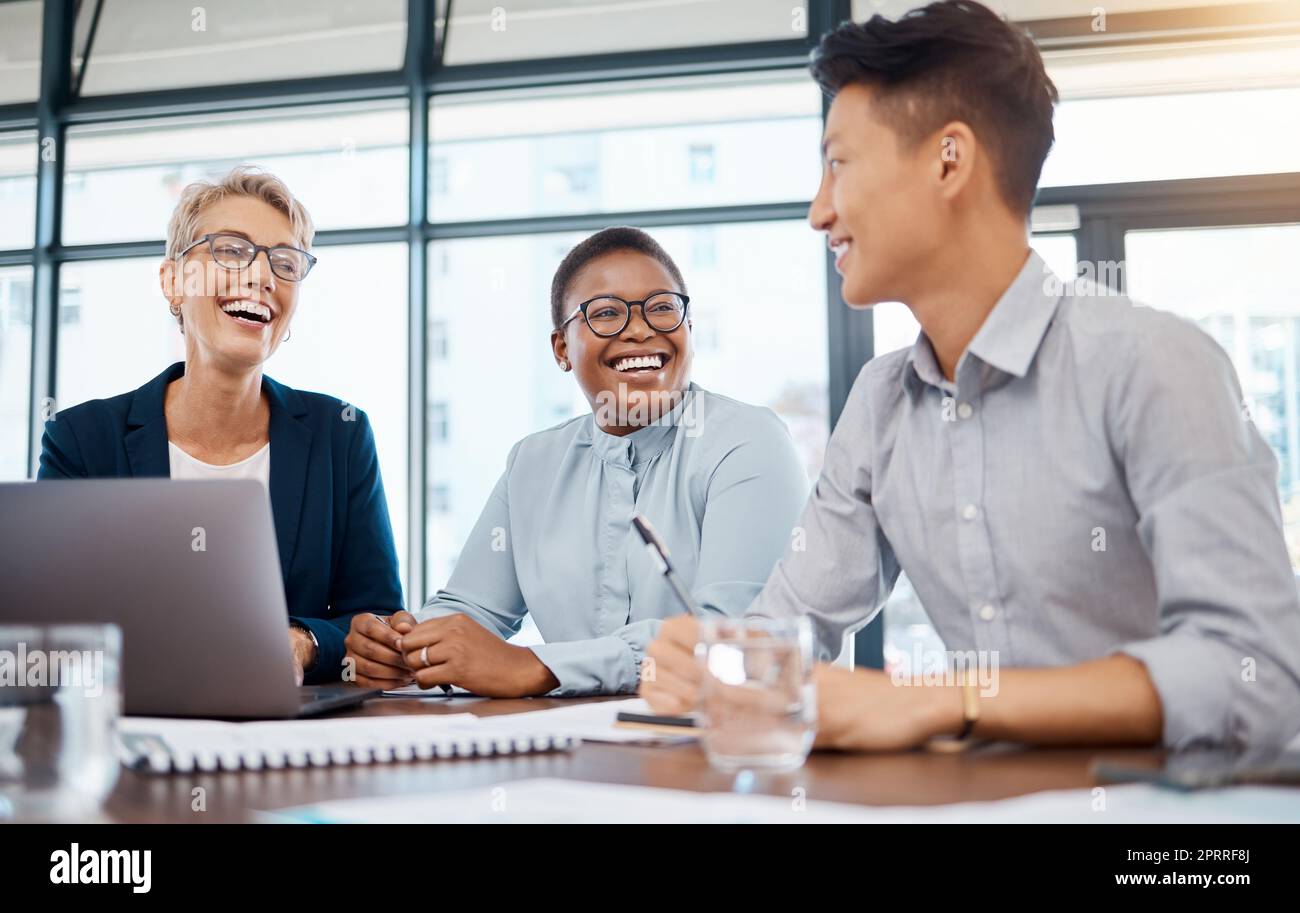 Global business, laughing and teamwork meeting in diversity collaboration, office strategy or digital marketing with laptop. Smile, happy and comic creative people excited about goal and success deal Stock Photo