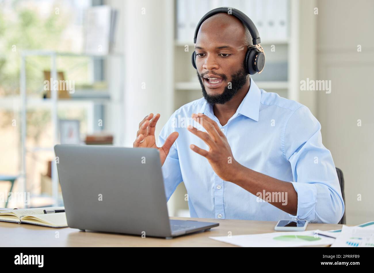 Black man, laptop and call center employee talking, training and in customer service, help and contact us support. Crm consulting office worker, receptionist or telemarketing communication consultant Stock Photo