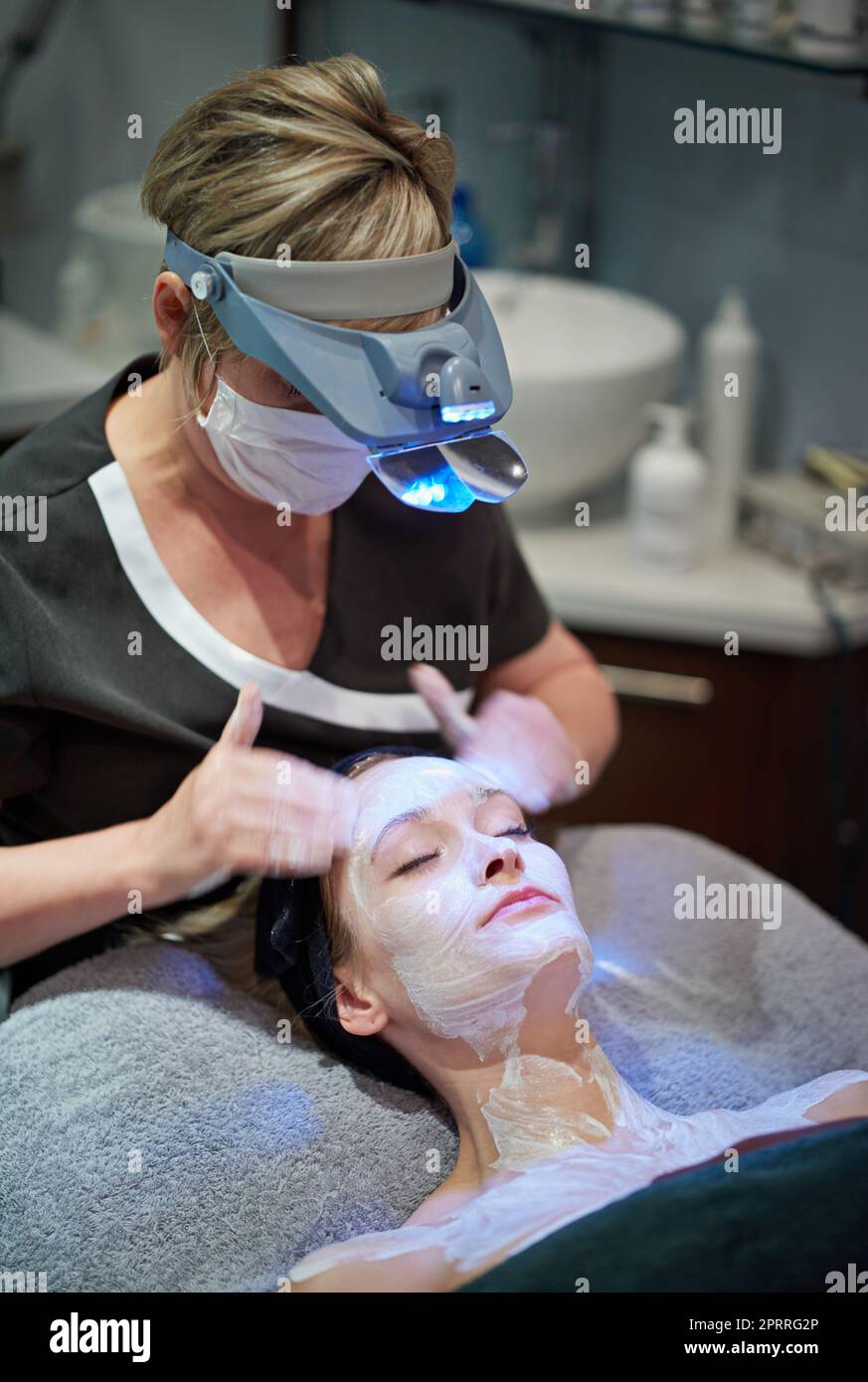 Rejuvenating youthfulness. a woman getting a facial treatment at a clinic. Stock Photo