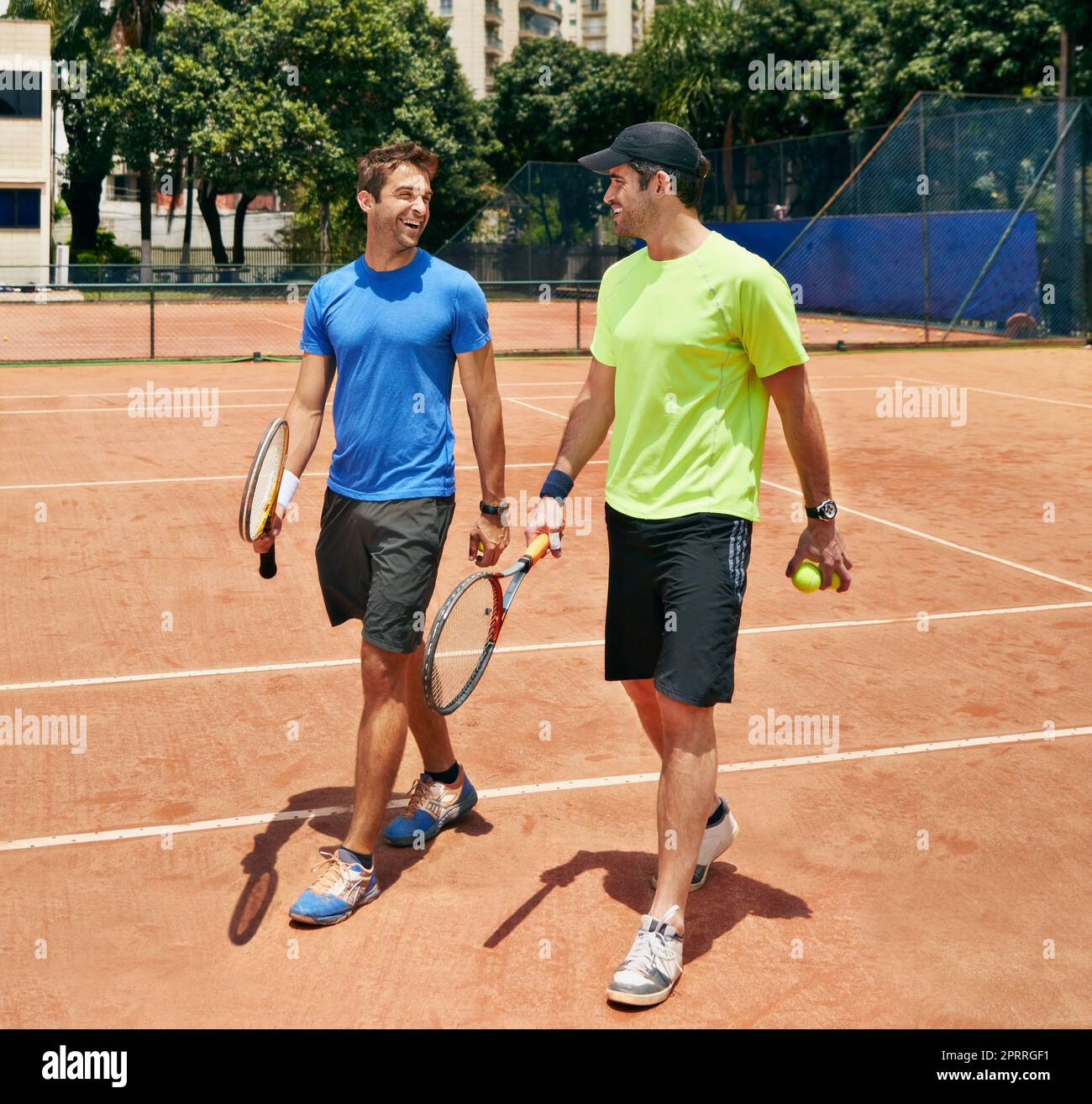 Keeping it friendly. two tennis players talking on the court after a friendly game. Stock Photo