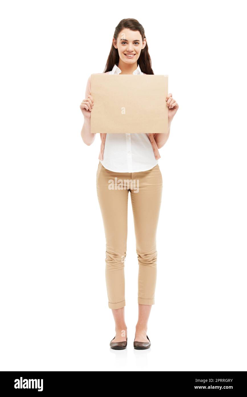 Boosting your brand with her smile. Smiling young woman holding up a small poster of copyspace. Stock Photo