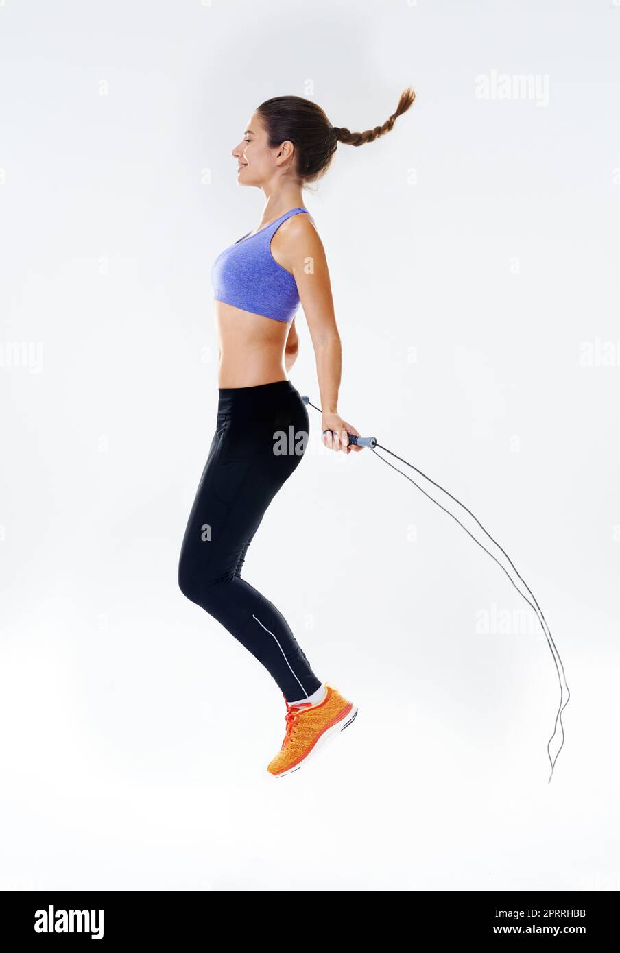 Working up a sweat. Studio shot of an attractive young woman working out. Stock Photo
