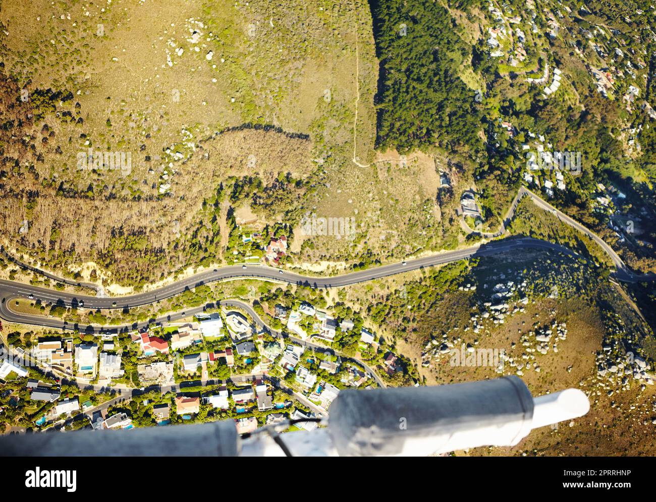 Winding through the countryside. Aerial shot of a road running through beautiful countryside. Stock Photo