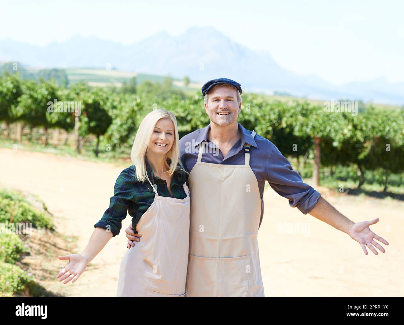 Our pride and joy. A married couple standing proudly in front of their farm. Stock Photo