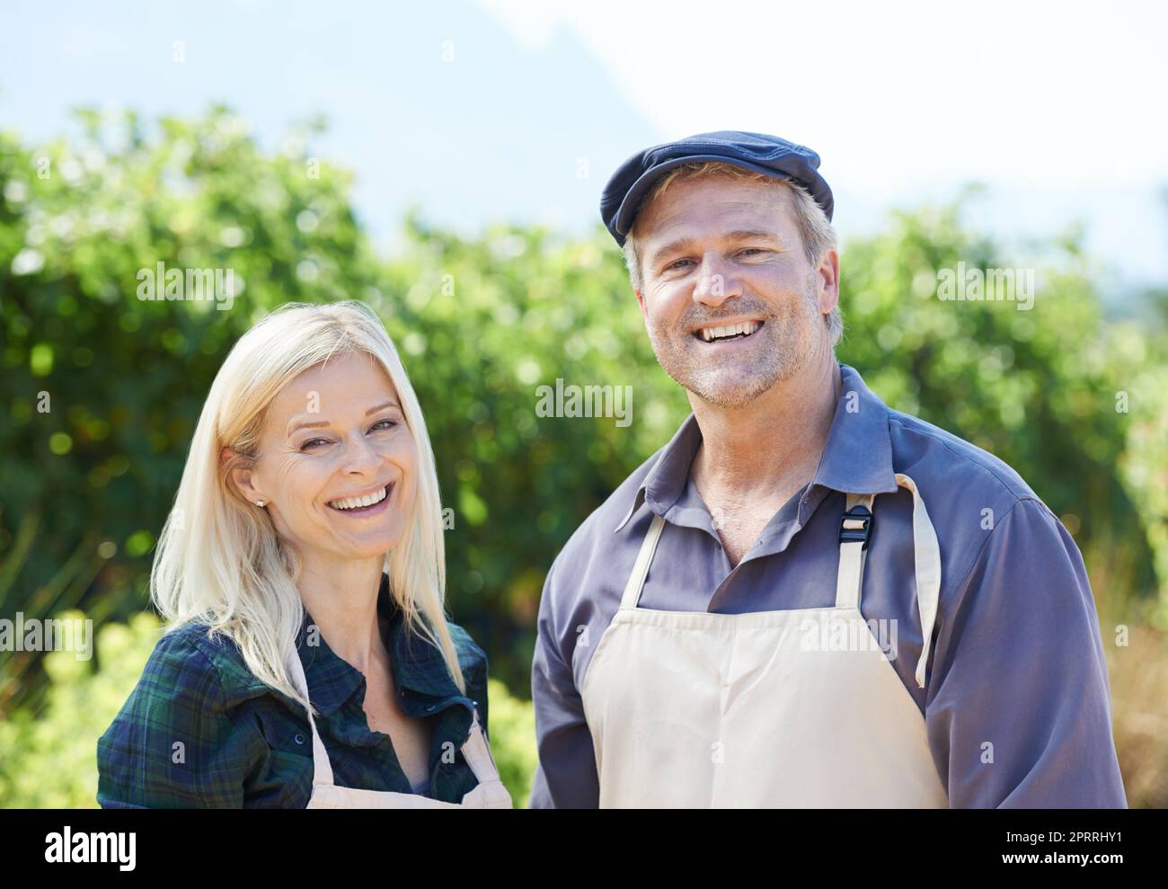 They share a passion for farming. A married couple standing proudly in front of their farm. Stock Photo