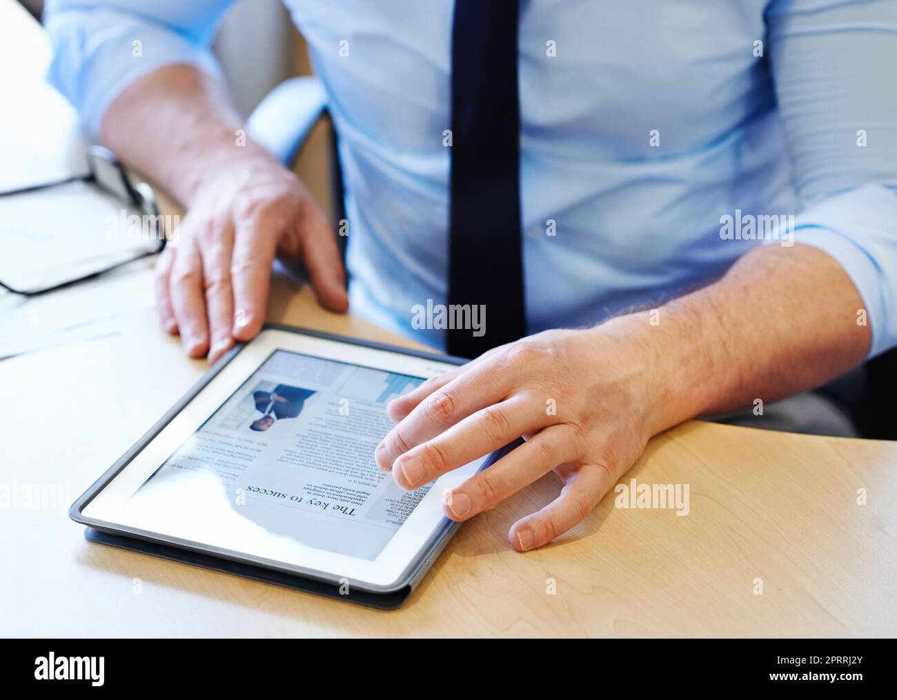Research is important to success. a businessman working on a digital tablet. Stock Photo