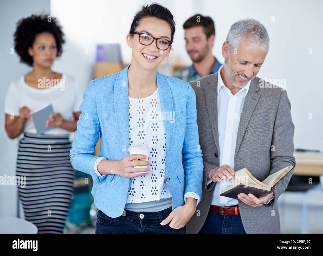 Theyre a multi-talented team. Portrait of a group of happy coworkers standing in an office. Stock Photo