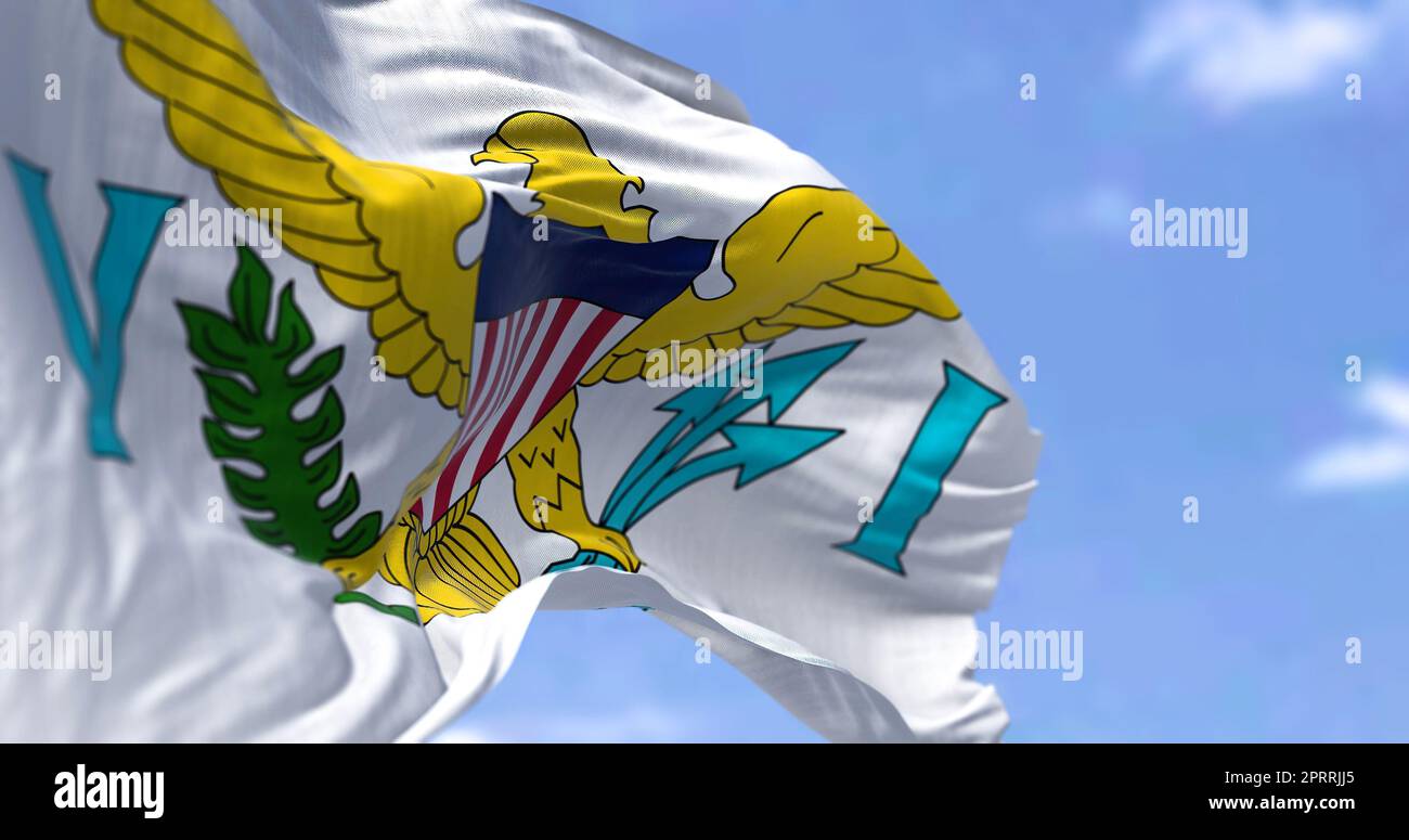 Flags of United States Virgin Islands waving in the wind with the US flag on a clear day Stock Photo